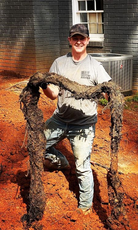 SepticRooter™ technician gets to the ROOT of the problem in Alpharetta — root-invaded septic pipe