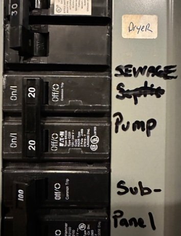 Home breaker panel with handwritten sewage pump label