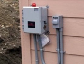 Clean new septic pump control panel installation on house exterior