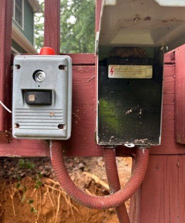 Septic alarm buzzer and disconnect panel mounted on house
